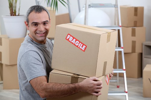 Packed boxes and protected furniture prepared for a Highbury house move