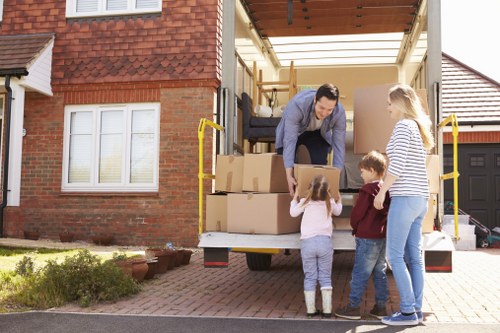 Movers carrying household items carefully through a Highbury property