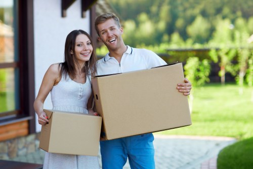 Local moving team handling boxes and furniture in Highbury