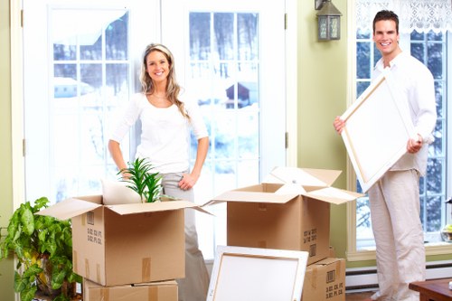 Wrapped sofas and household furniture prepared for transport during a local Highbury move
