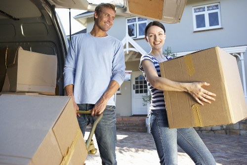 Professional moving team loading household items into a van